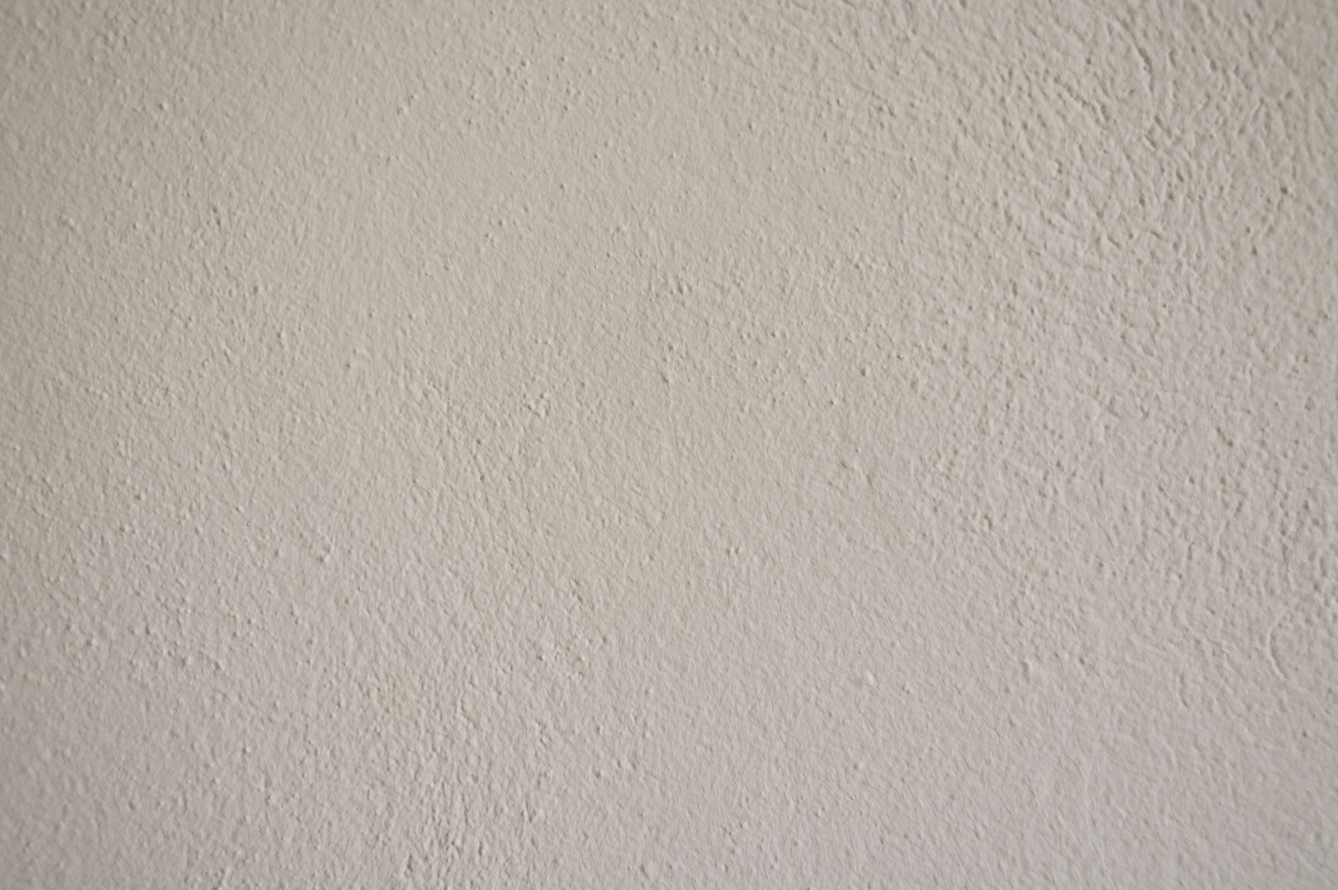 A close-up view of a textured white wall suitable for creative design projects.